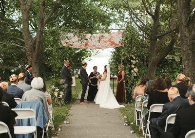 Photo of a bride and groom standing under the chuppah
